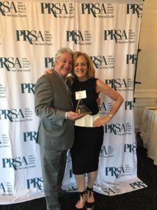 alt="Amy Stern and Dave Scelba holding PRSA Pyramid Award"