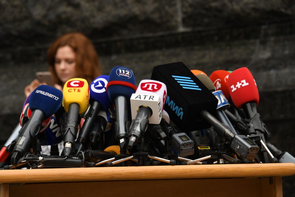 alt=news-outlet-microphones-at-podium